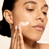 Model applying Microbiome Restorative Evening Moisturizer.