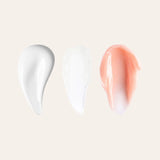 Three lip care swatches on a beige background white cream white balm and peach tinted cream